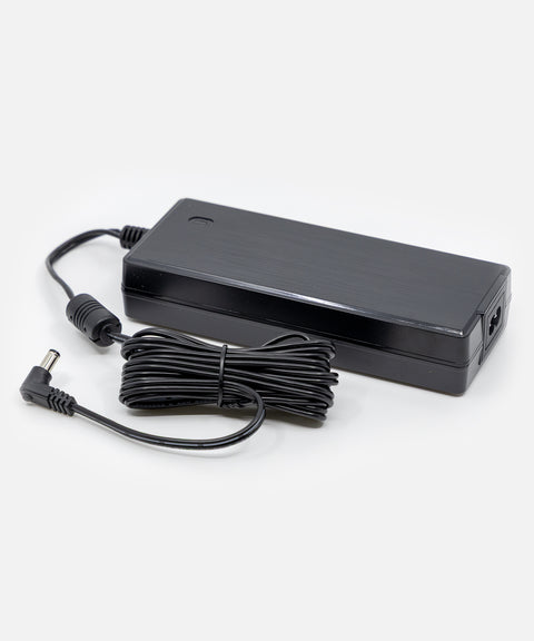 NEOZ 120W power supply with coiled DC cable – sleek black charger for Large Charging Tray, designed for up to 12 cordless lamps.