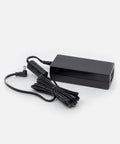 NEOZ 65W power supply with coiled DC cable – sleek black charger for N1 Charging Tray supporting up to six cordless lamps.