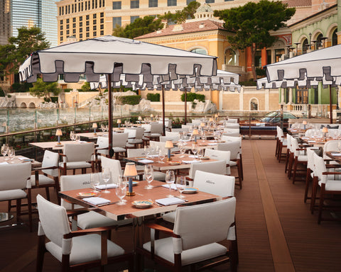 Custom portable table lamp illuminating dining table at Carbone Riviera Las Vegas